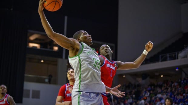 Mar 11, 2022; Frisco, TX, USA; North Texas Mean Green forward Abou Ousmane (33) drives to the basket past Louisiana Tech Bulldogs forward Kenny Hunter (1) during the second half of the men s basketball semi-finals of the USA Conference Tournament at Ford Center at The Star. Mandatory Credit: Jerome Miron-USA TODAY Sports